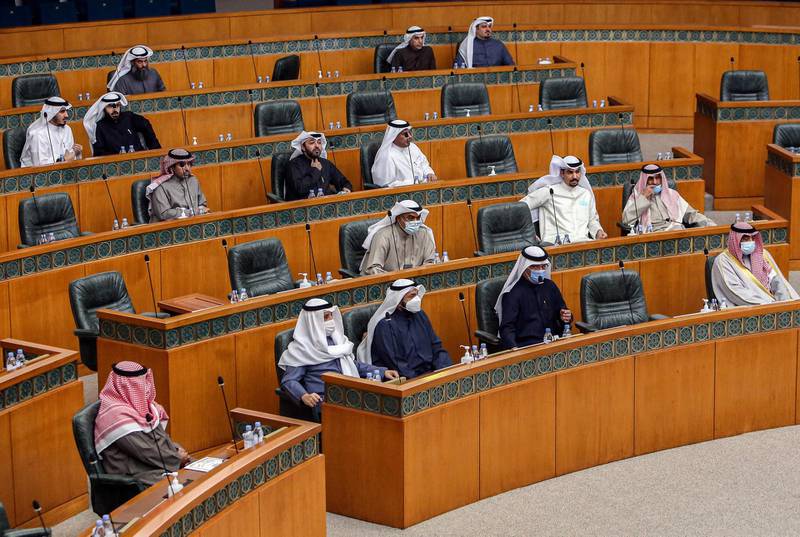 Kuwaiti MPs attend a special session at the National Assembly headquarters in Kuwait City to review government measures to limit the spread of Covid-19. AFP