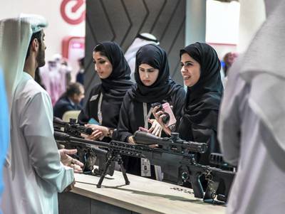 Abu Dhabi, U.A.E., February 20, 2019. INTERNATIONAL DEFENCE EXHIBITION AND CONFERENCE  2019 (IDEX) Day 4--  Colour images.-- Visitors at the show look at some Caracal firearms.Victor Besa/The NationalSection:  NA