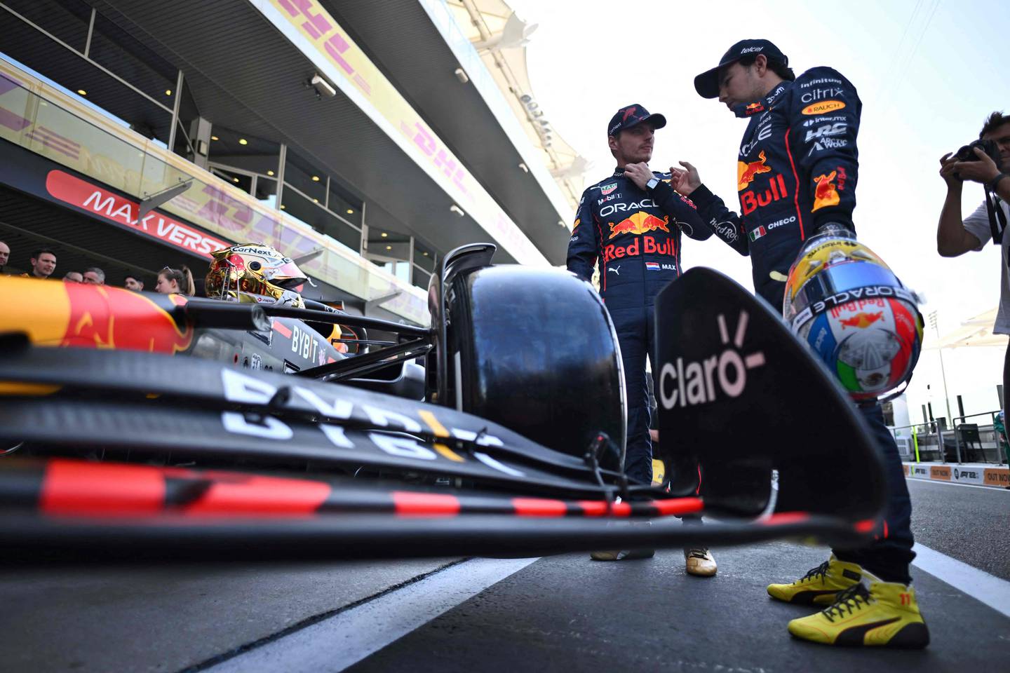 Le pilote néerlandais de Red Bull, Max Verstappen, discute avec le pilote mexicain de Red Bull, Sergio Perez, avant une séance photo d'équipe avant le Grand Prix de Formule 1 d'Abu Dhabi.  AFP