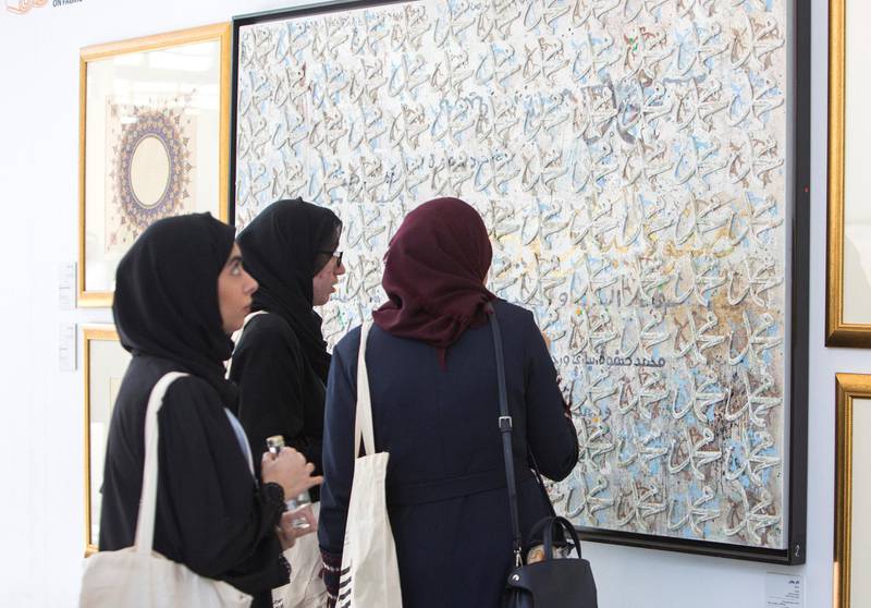 ABU DHABI, UNITED ARAB EMIRATES -Attendees looking at an artwork at the Al Burda Festival, Shaping the Future of Islamic Art and Culture at Warehouse 421, Abu Dhabi.  Leslie Pableo for The National for Melissa Gronlund’s story