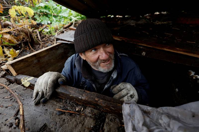 Myhaylo Yurkiv, 65, climbs out of the small bunker in Tsupivka, Ukraine, in which he stayed for six months during fierce battles under Russian occupation. Every home was destroyed and the village was cut in two by the shelling of the bridge, leaving him now as the only person living on his side of the village. Reuters