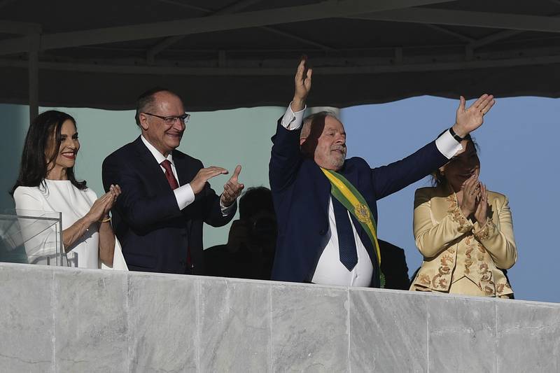 Brazil's new President Luiz Inacio Lula da Silva acknowledges supporters, alongside Vice President Geraldo Alckmin, first lady Rosangela da Silva, right, and Mr Alckmin's wife, Maria Lucia Ribeiro Alckmin. AFP