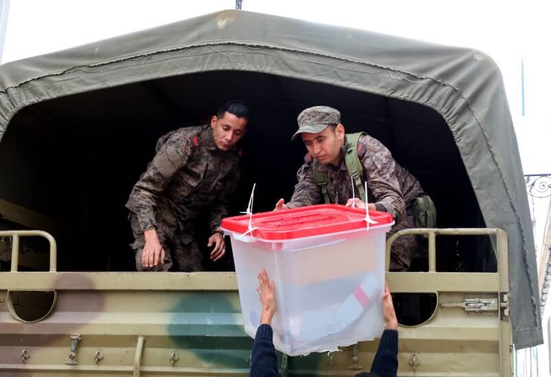 The Tunisian army unloads ballot boxes at a polling station in Tunis on Friday. EPA