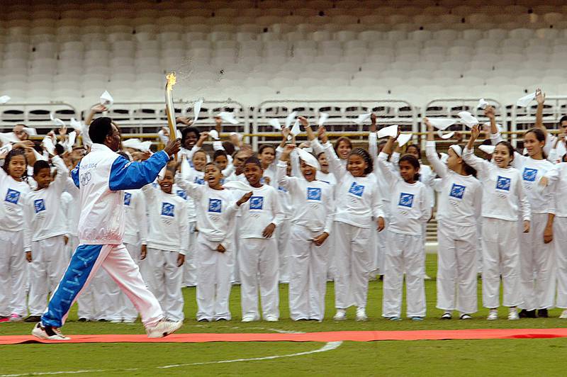 Carrying the Olympic Torch out of Maracana Stadium, on Day 10 of the Athens 2004 Olympic Torch Relay, in Rio De Janiero. The Olympic Flame travelled to 34 cities in 27 countries en route to the Games in Athens. AFP