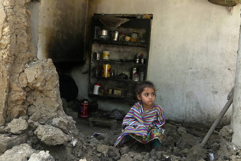 A girl sits amid the rubble of her damaged home in Charsadda district, Khyber Pakhtunkhwa province. AP