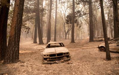 Burnt vehicles in Indian Falls, California. At least 16,500 people have fled the Dixie fire.