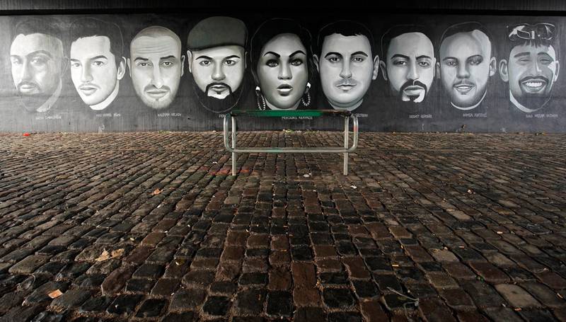 A mural of portraits of the victims of the shooting on a wall under a bridge in Frankfurt. EPA