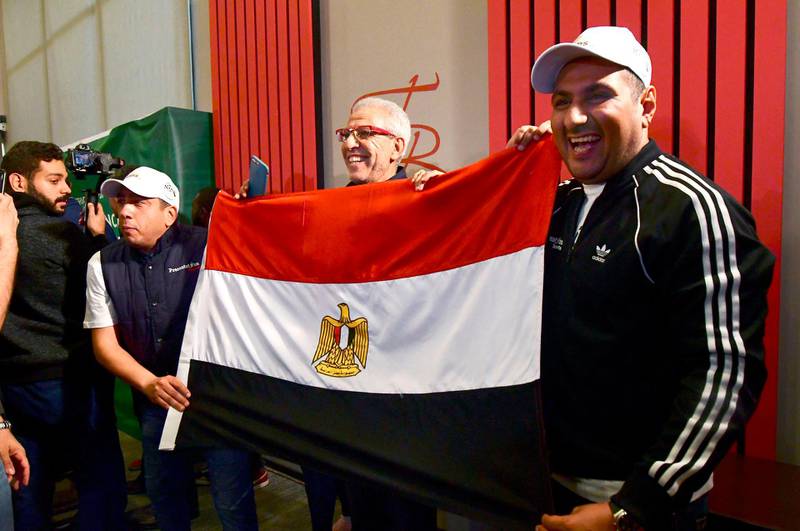 Egyptian representatives pose with their national flag as they celebrate the Confederation of African Football (CAF) executive committee's decision to choose Egypt to host the 2019 Africa Cup of Nations between June 15 and July 13, in an Hotel in Dakar on January 8, 2019. The CAF executive committee preferred Egypt to South Africa as replacements for original hosts Cameroon, who were dropped due to delays in preparations and concerns over security. It will be the fifth time Egypt stage the biennial showpiece of African football after 1959, when the country was called the United Arab Republic, 1974, 1986 and 2006.
 / AFP / SEYLLOU
