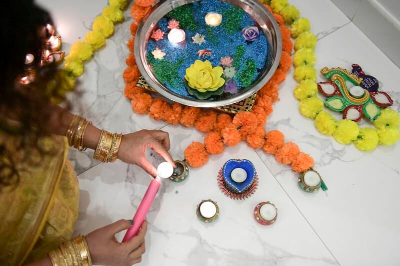 Prgati Grover lights the candles for Diwali. Khushnum Bhandari / The National
