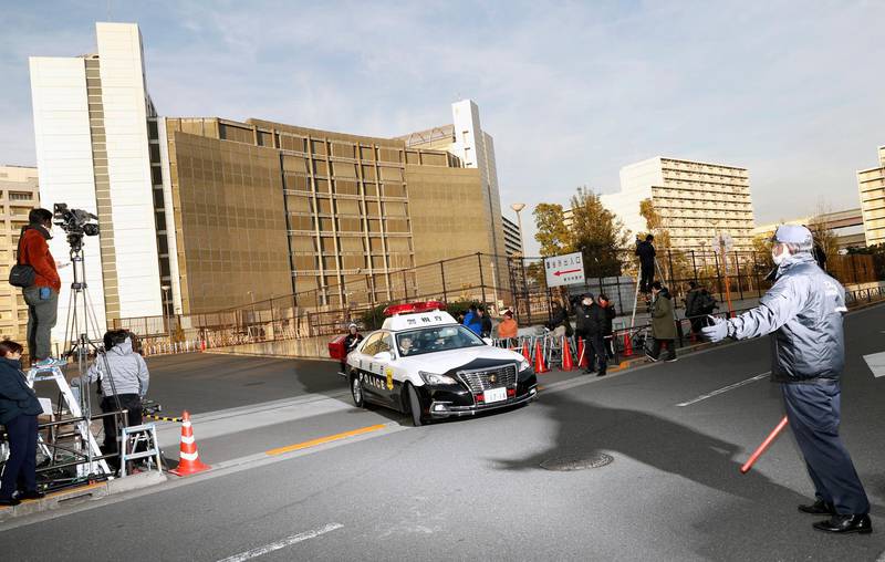 A police car drives away from Tokyo Detention Center, where former Nissan chairman Carlos Ghosn and another former executive Greg Kelly, are being detained, in Tokyo Tuesday, Dec. 25, 2018. A Japanese court approved a bail request Tuesday for Nissan Motor Co. executive Kelly, who was detained and charged with underreporting the income of his boss, former Nissan chairman Ghosn. (AP Photo/Eugene Hoshiko)