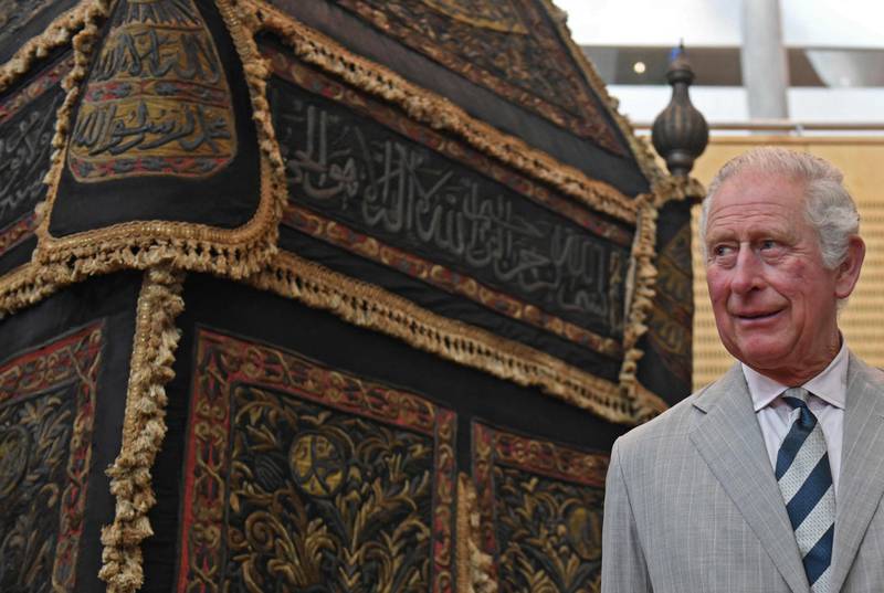 Prince Charles stands next to the 'mahmal', the palanquin formerly used to transport the 'kiswa' protective cover that engulfs Islam's holiest shrine the Kaaba from Egypt to Mecca, during his visit to the Bibliotheca Alexandrina. AFP