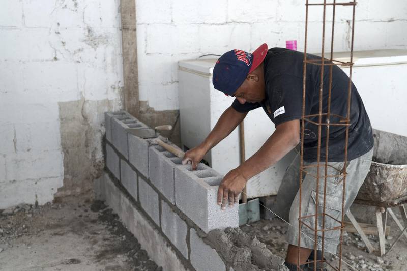 A construction worker builds a wall at the Sidewalk School in Reynosa, Mexico. The National / Willy Lowry