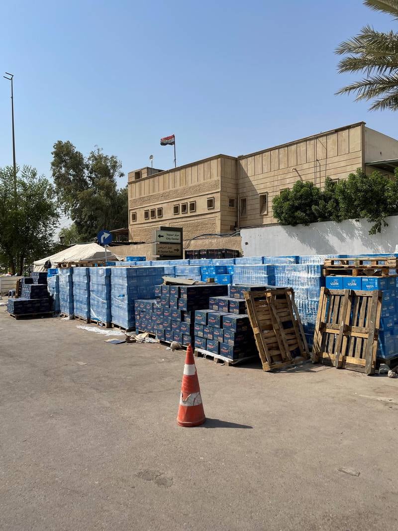 Packs of bottled water and food are stacked outside the parliament building, sent by volunteers for the protesters.