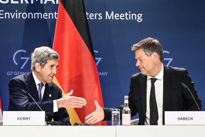 US climate envoy John Kerry and German Vice Chancellor Robert Habeck shake hands at the G7 talks in Berlin. EPA