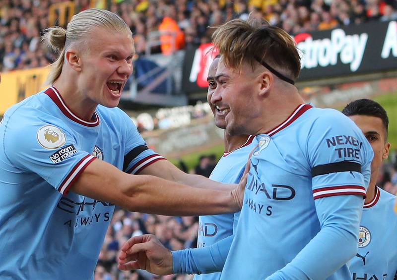 Erling Haaland celebrates with goalscorer Jack Grealish in Manchester City's win against Wolves on September 17, 2022. AFP