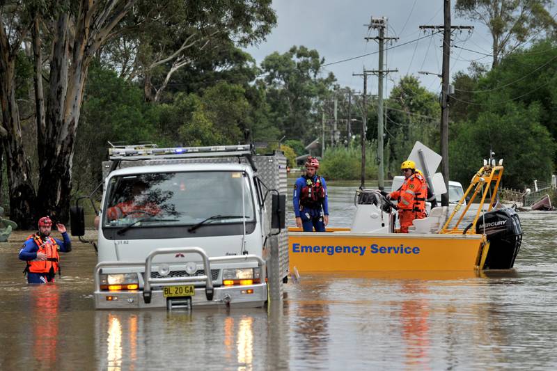Volunteers from the State Emergency Service (SES) rescue animals from flooded farm houses in western Sydney. AFP