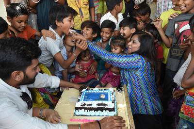 Narendra Modi Fan Club members offer cake to underprivileged children as they celebrate his swearing-in ceremony iN Ahmedabad. AFP