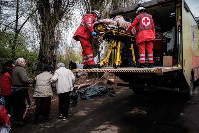 Members of the Ukrainian Red Cross carry a woman, 92, to an ambulance from a bunker at a factory in Severodonetsk. AFP