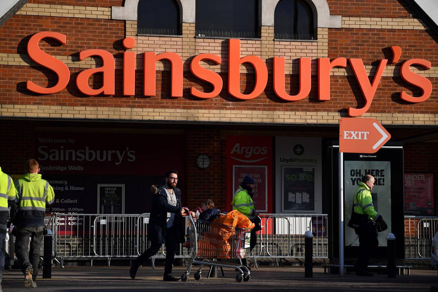 A shopper leaves a Sainsbury's supermarket in Tunbridge Wells on January 7, 2021. Sainsbury’s has upgraded its profit expectations by £60m after surging sales of champagne, steaks and other luxury food drove stronger than expected sales over Christmas and new year. / AFP / Ben STANSALL
