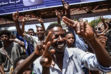 Sudanese protesters flash the V for victory sign as they chant slogans during a protest near the military headquarters in the capital Khartoum. AFP