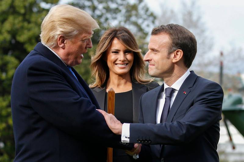 US President Donald Trump (L), with First Lady Melania Trump (C) shakes hands with French President Emmanuel Macron (R) during a tree planting ceremony on the South Lawn of the White House in Washington, DC, USA, on April 23, 2018. Shawn Thew / EPA