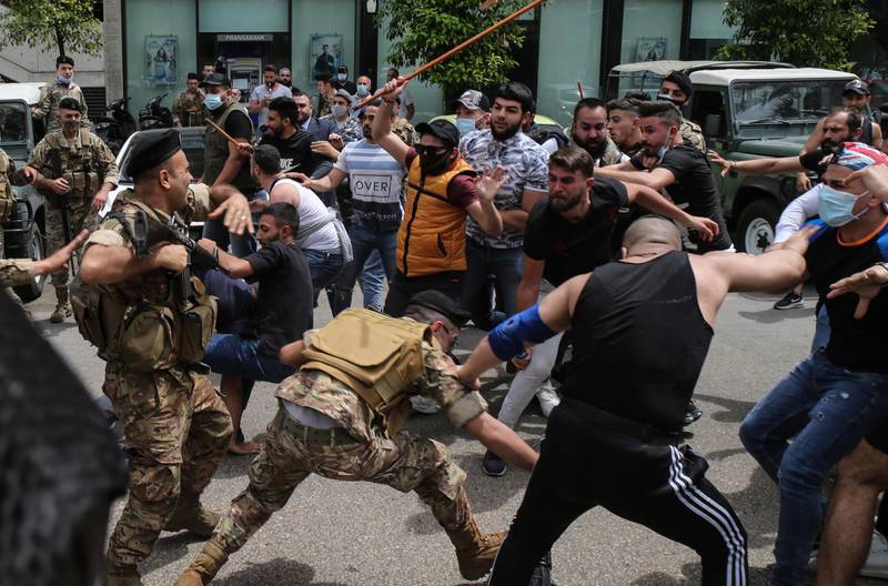 Supporters of Lebanon's top prosecutor Ghassan Oueidat clash with security forces during their protest against Judge Ghada Aoun, the chief prosecutor of the Mount Lebanon region, in Beirut, Lebanon. EPA