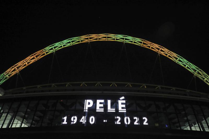 Wembley Stadium's arch is lit up in the colours of Brazil to pay tribute to Pele. PA