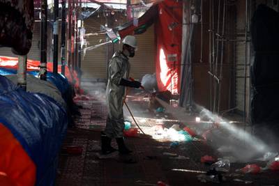 A worker sprays disinfectant at an empty market in Sanaa, Yemen.  EPA