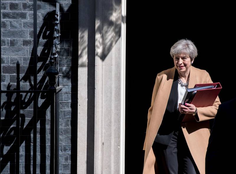 British Prime Minister Theresa May leaves 10 Downing Street in central London on April 19, 2017 ahead of the weekly Prime Minister's Questions session in the House of Commons. - British Prime Minister Theresa May called on April 18 for a snap election on June 8, in a shock move as she seeks to bolster her position before tough talks on leaving the EU. MPs are set to vote on the motion following Prime Minister's Questions in the House of Commons. (Photo by CHRIS J RATCLIFFE / AFP)