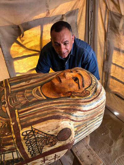 Egyptian Secretary General of the Supreme Council of Antiquities Mostafa Waziri inspects one of 14 2,500-year-old coffins discovered in a burial shaft at the desert necropolis of Saqqara. AFP