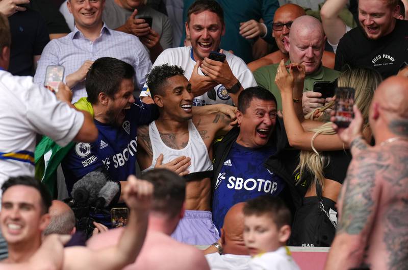 Leeds United's Raphinha celebrates in the stands with away fans at the Brentford Community Stadium. PA