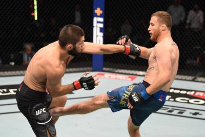 ABU DHABI, UNITED ARAB EMIRATES - OCTOBER 25: In this handout image provided by UFC, (R-L) Justin Gaethje kicks Khabib Nurmagomedov of Russia in their lightweight title bout during the UFC 254 event on October 25, 2020 on UFC Fight Island, Abu Dhabi, United Arab Emirates. (Photo by Josh Hedges/Zuffa LLC via Getty Images)