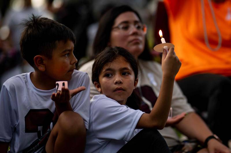 Families take part in a candlelight vigil to honour the 19 children and two adults killed on May 24, 2022, during a mass shooting at Robb Elementary School in Uvalde, Texas. Getty/AFP