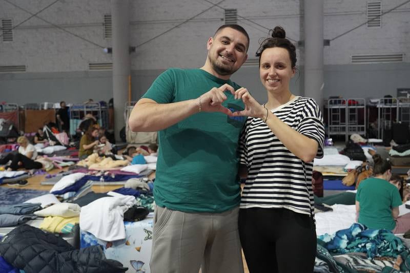 Victoria and her partner fled Kyiv for the US. Here they pose inside a refugee camp in Tijuana, Mexico.