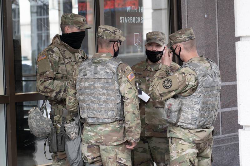 Members of the National Guard gather outside the Grand Hyatt Hotel in Washington. Willy Lowry / The National