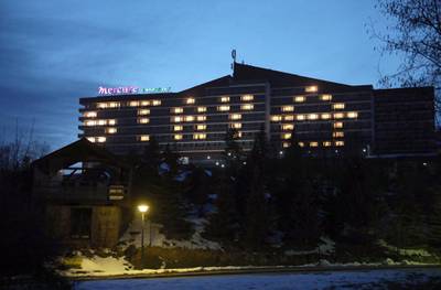 Lights left on in rooms of an empty hotel read 'stay home' in the mountain resort of Zakopane, Poland. EPA