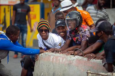Protesters set up a barricade on a street during a nationwide strike demanding the resignation of Haitian President Jovenel Moise, in Port-au-Prince, Haiti. AP