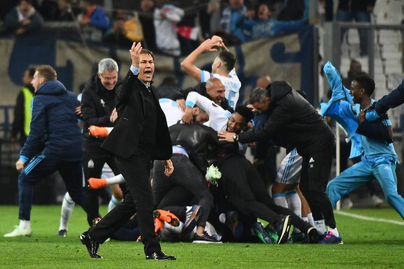 Marseille's French coach Rudi Garcia and players celebrate after winning the Europa League quarter-final second leg against RB Leipzig at the Velodrome in Marseille, on April 12, 2018. AFP