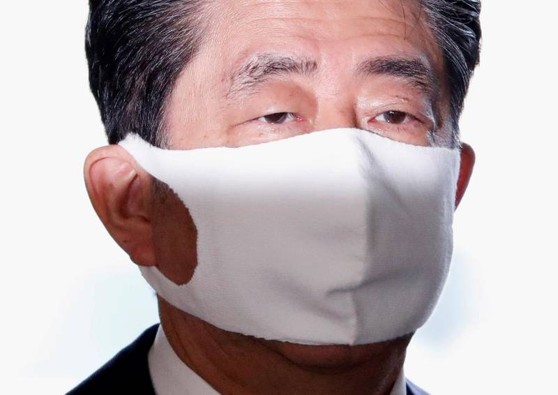 Japan's Prime Minister Shinzo Abe wears a face mask as he arrives at his official residence in Tokyo on August 28, 2020. Reuters
