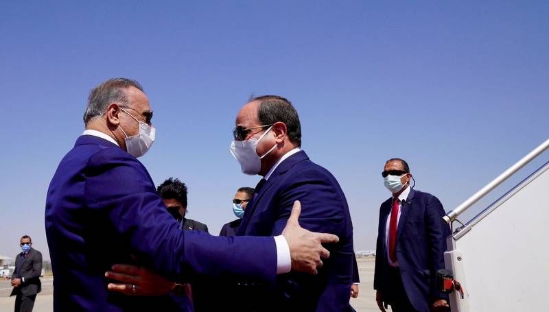 Iraqi Prime Minister Mustafa Al Kadhimi welcomes Egyptian President Abdel Fattah El Sisi upon his arrival for a one-day regional summit hosted by Baghdad. Reuters