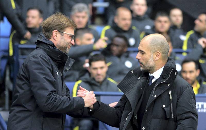 Liverpool manager Juergen Klopp, left, and Manchester City manager Pep Guardiola shake hands before the English Premier League soccer match between Manchester City and Liverpool at the Etihad Stadium in Manchester, England, Sunday March 19, 2017. (AP Photo/Dave Thompson)