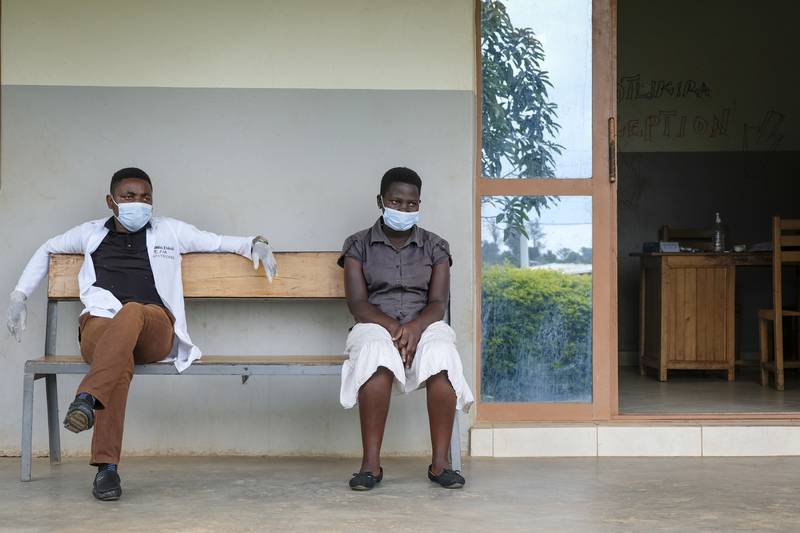 Nurse Edgar Muhindo, left, at St Florence Clinic in Madudu, which unknowingly treated two Ebola patients for malaria before they sought care elsewhere. AP