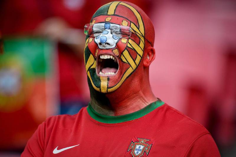 A supporter of Portugal’s football team sings the national anthem before the friendly football match Portugal vs Estonia at Luz stadium in Lisbon, in preparation for the upcoming UEFA Euro 2016 Championship. Patricia De Melo Moreira / AFP