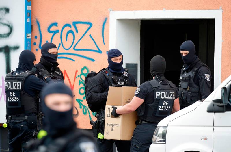 Police carry evdence in a moving box out of Al-Irschad Mosque during a raid in Berlin.  AFP