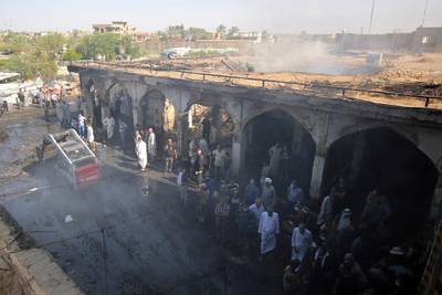 Iraqis look at the damage at aftermath scene of a mortar and bombing attack on the Sayyid Mohammed shrine in the Balad area, located 70 kilometres (around 45 miles) north of Baghdad, on July 8, 2016. - The Islamic State group carried out the attack on the Shiite shrine that killed 30 people, the jihadist-linked Amaq agency said. It came just five days after a suicide bomber detonated an explosives-rigged minibus in the capital, killing 292 people. (Photo by AHMAD AL-RUBAYE / AFP)