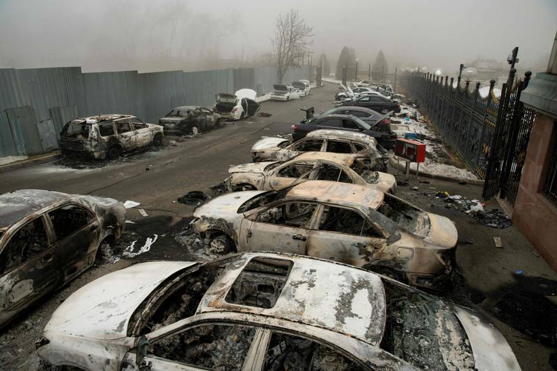 Burnt-out cars in central Almaty. Authorities said at least 18 members of the security forces have been killed in the violence in the city. AFP