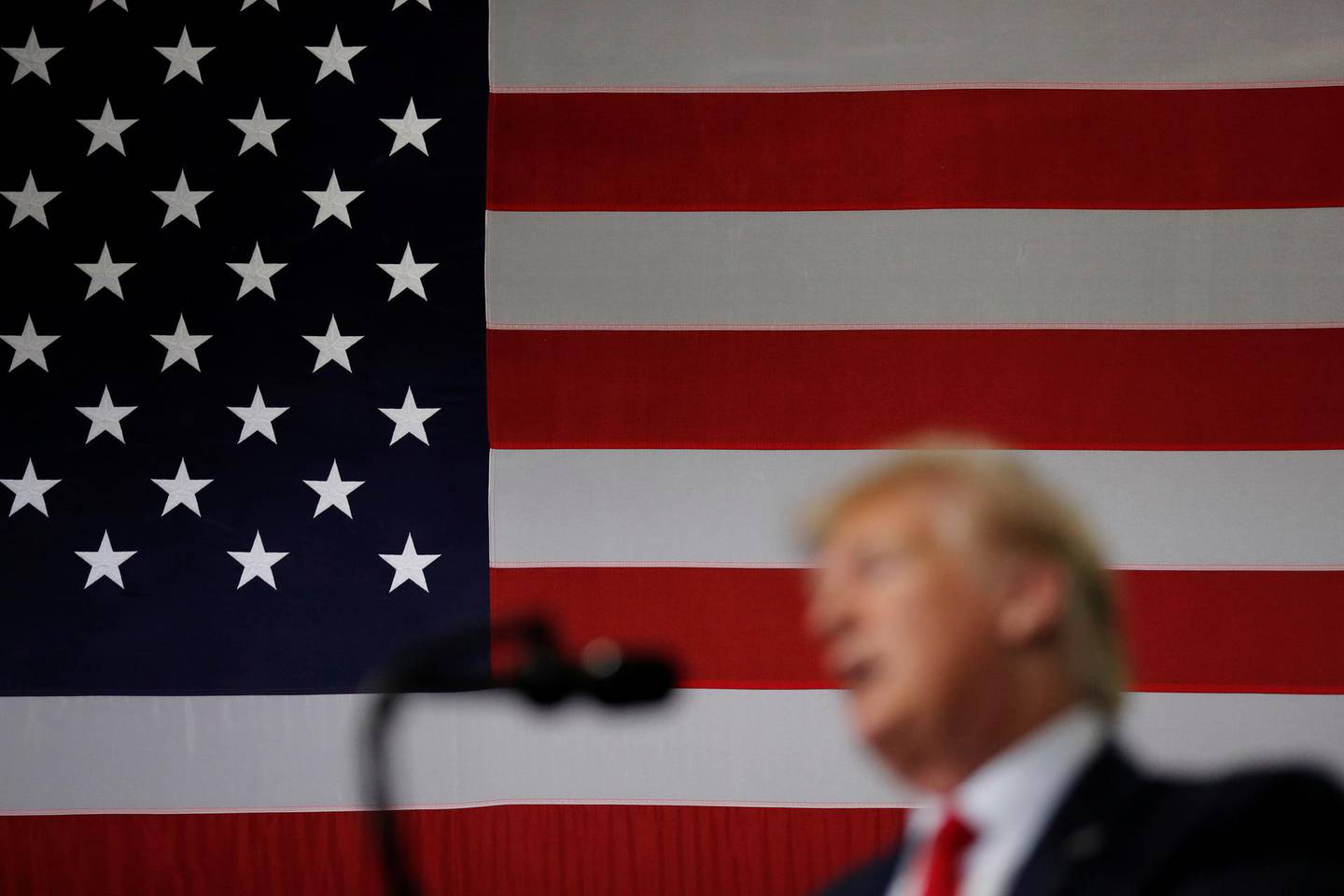 With a U.S. flag as a backdrop, U.S. President Donald Trump delivers remarks on supporting the passage of the U.S.-Mexico-Canada (USMCA) trade deal during a visit to Derco Aerospace Inc., a Lockheed Martin subsidiary, in Milwaukee, Wisconsin, U.S., July 12, 2019. REUTERS/Carlos Barria