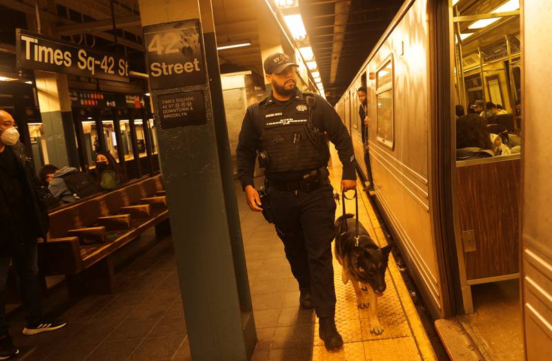 A police officer and dog check a subway station in Manhattan after the Brooklyn incident. Reuters