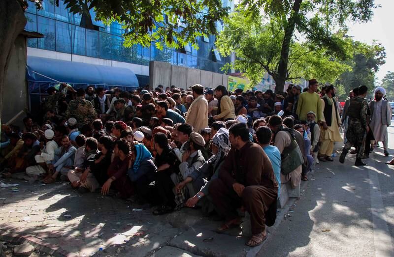 People queue to withdraw money from a bank in Kabul, Afghanistan, on September12. EPA