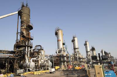 Workers repair a damaged refining tower at Saudi Aramco's Abqaiq crude oil processing plant following a drone attack in Abqaiq, Saudi Arabia, on Friday, Sept. 20, 2019. Saudi Aramco revealed the significant damage caused by an aerial strike on its Khurais oil field and Abqaiq crude-processing plant last weekend, and insisted that the sites will be back to pre-attack output levels by the end of the month. Photographer: Faisal Al Nasser/Bloomberg